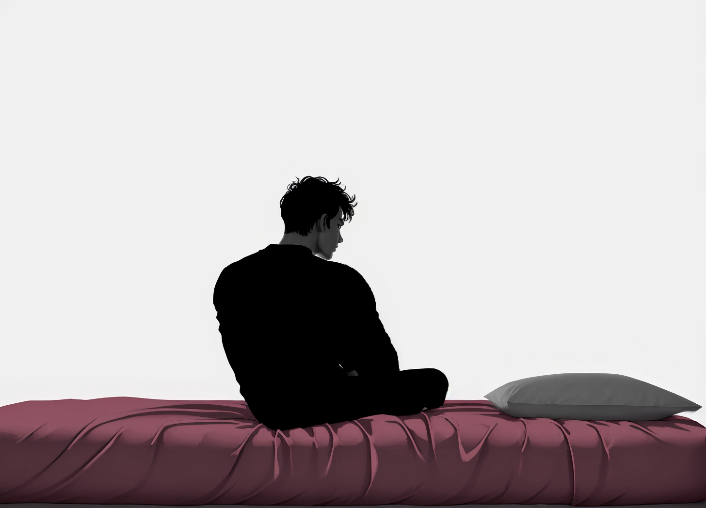 young man sitting on a bed